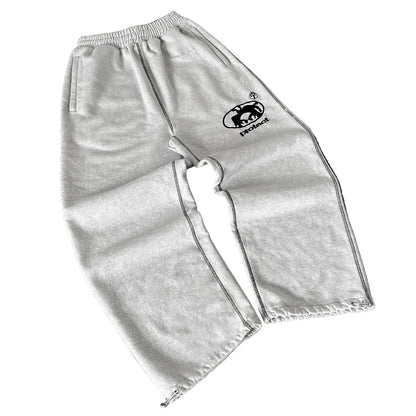 Gray sweatpants with a logo on a dark surface