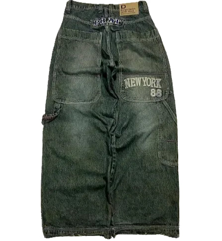 Green denim shorts with branding on a white background