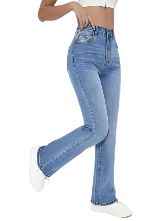 Person wearing blue jeans and white sneakers on a plain background