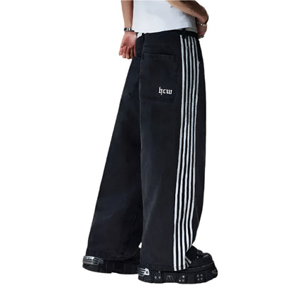 Black pants with white stripes and 'hcw' branding on a plain background