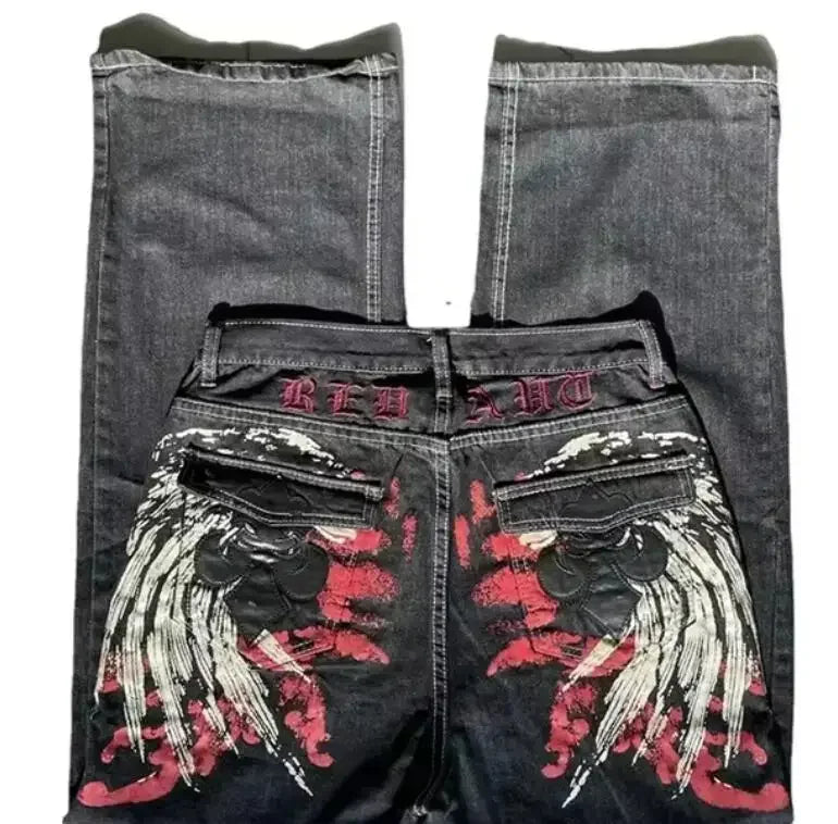 Black jeans with red and white floral embroidery on a white background