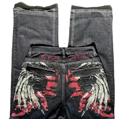 Black jeans with red and white floral embroidery on a white background