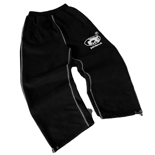 Black pants with a logo on a gray surface