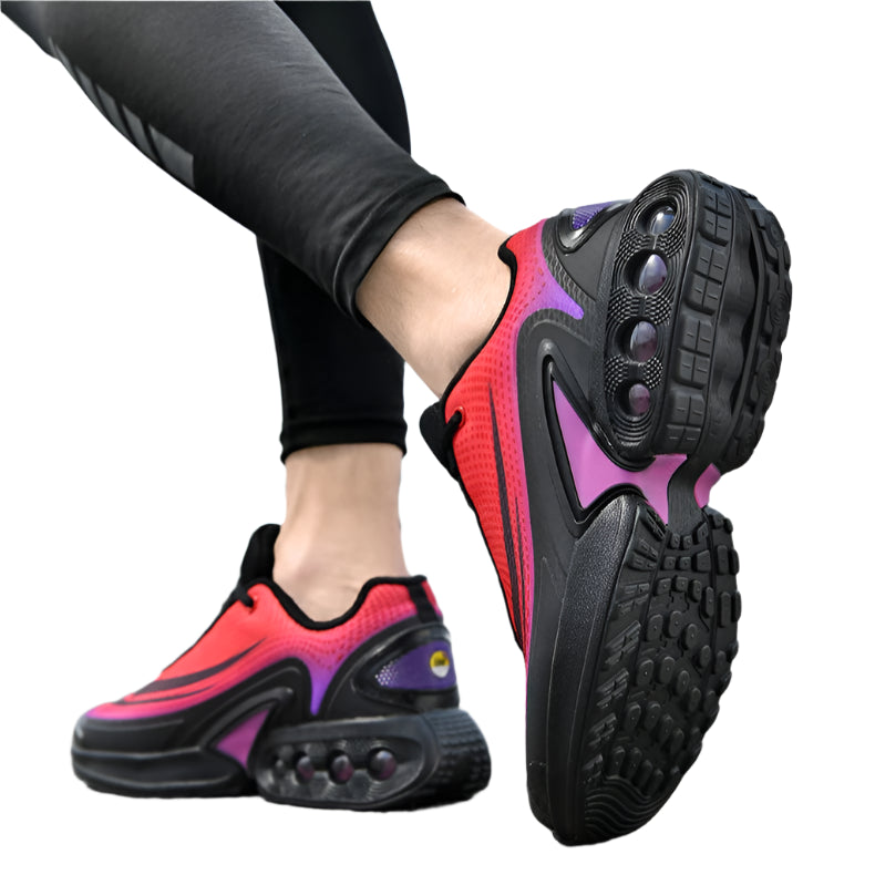 Person wearing black and red athletic shoes with a blurred background