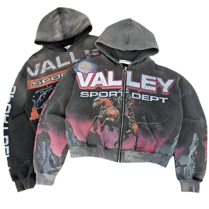 Two hoodies with 'Valley Sport Dept' branding on a textured surface